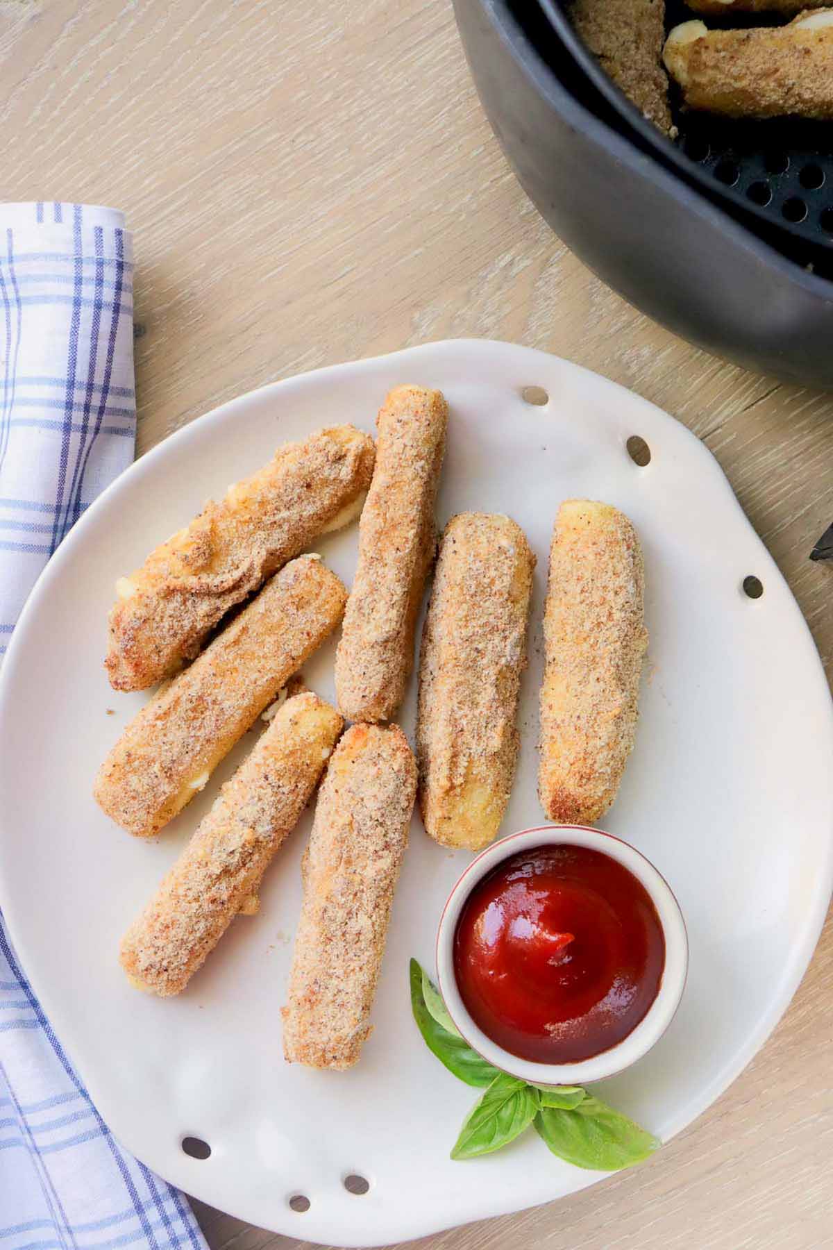 Mozzarella sticks on a white plate.