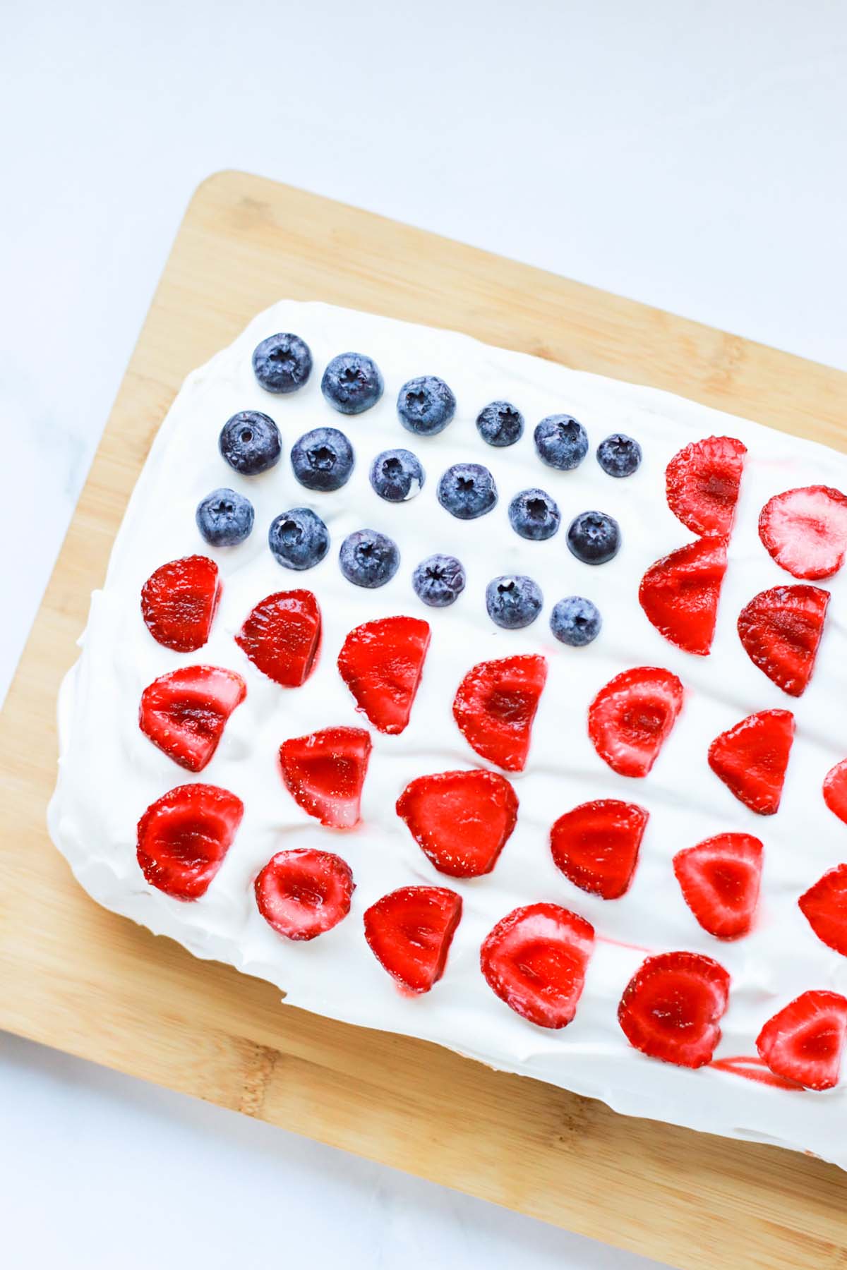 top view of a flag cake on a cutting board.