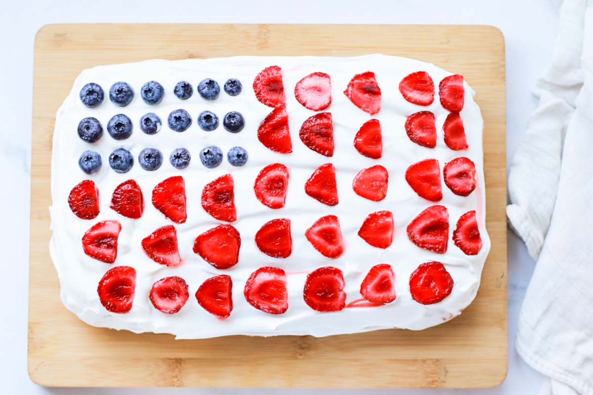 Flag cake topped with blueberries and strawberries.