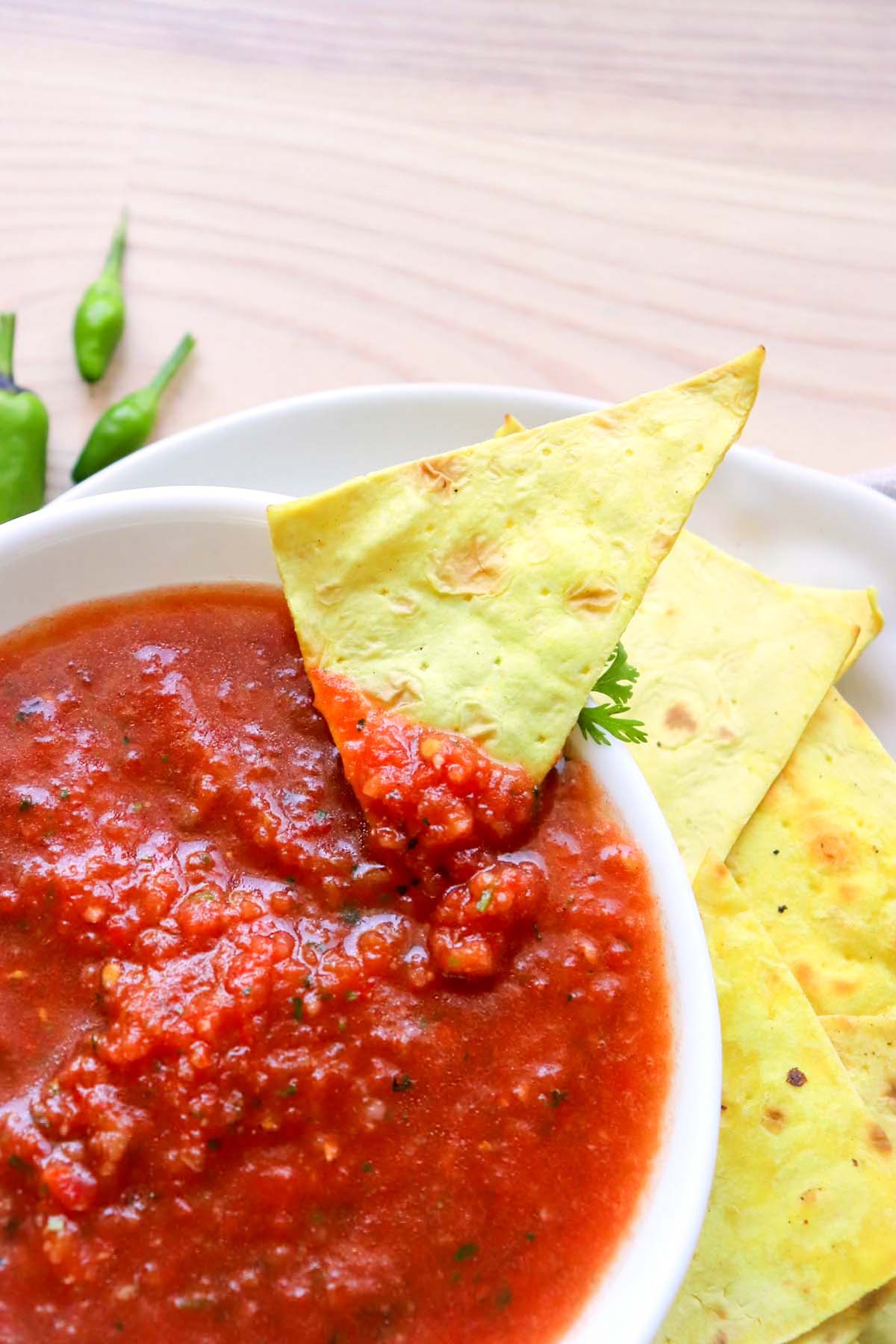 A tortilla chip dipped in salsa.