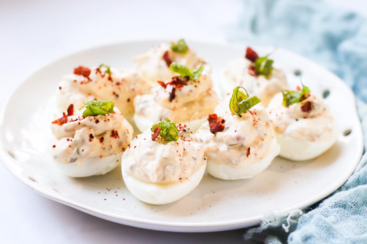 Deviled eggs topped with bacon and jalapeño.
