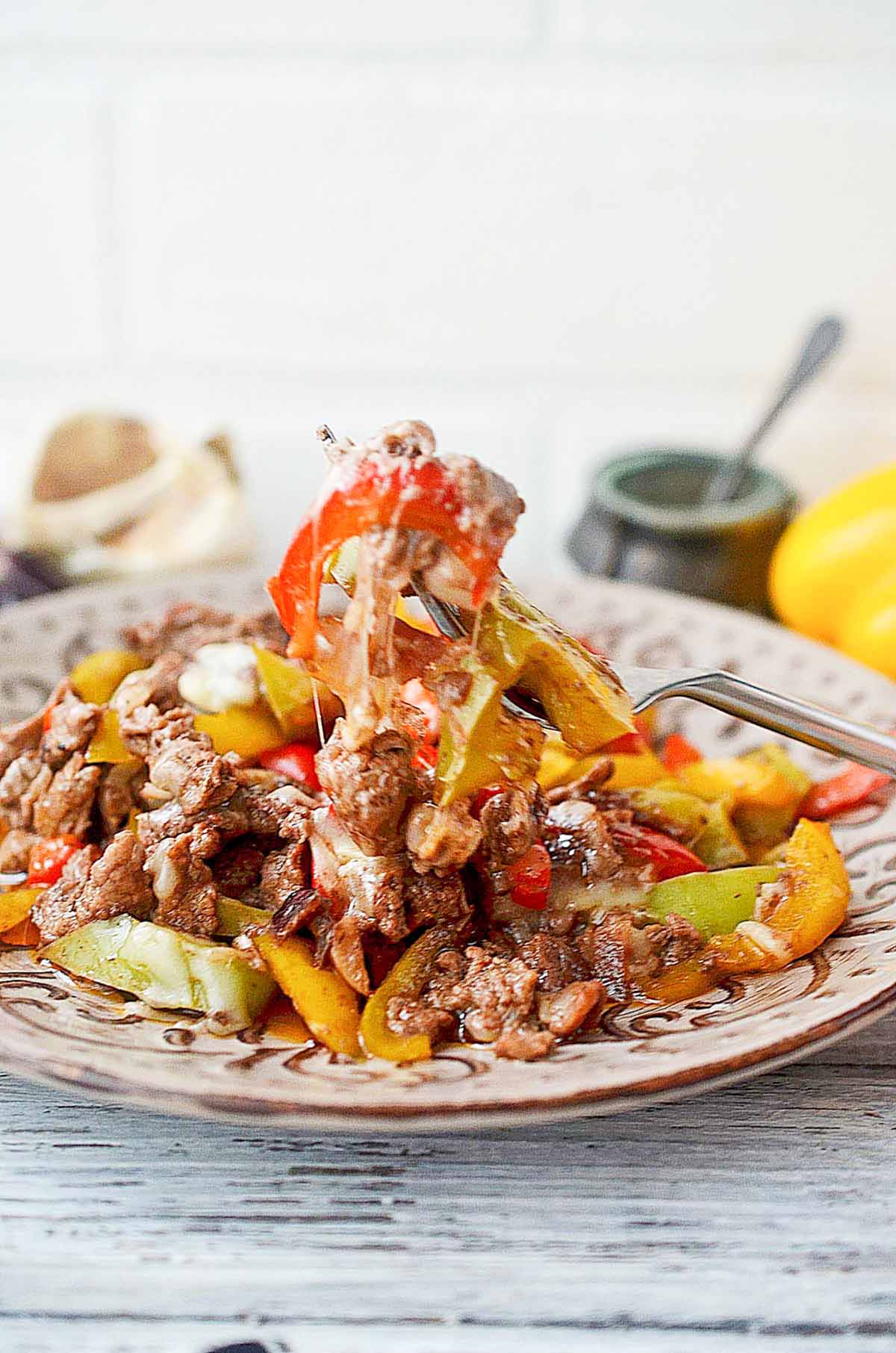 beef and pepper stir fry on a fork.