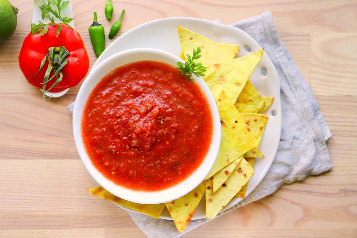 Salsa in a bowl set on a kitchen towel.