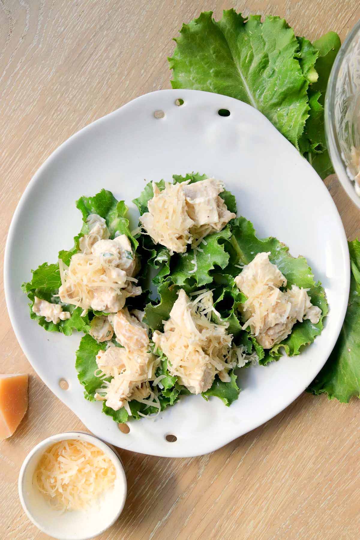five chicken lettuce wraps on a plate.