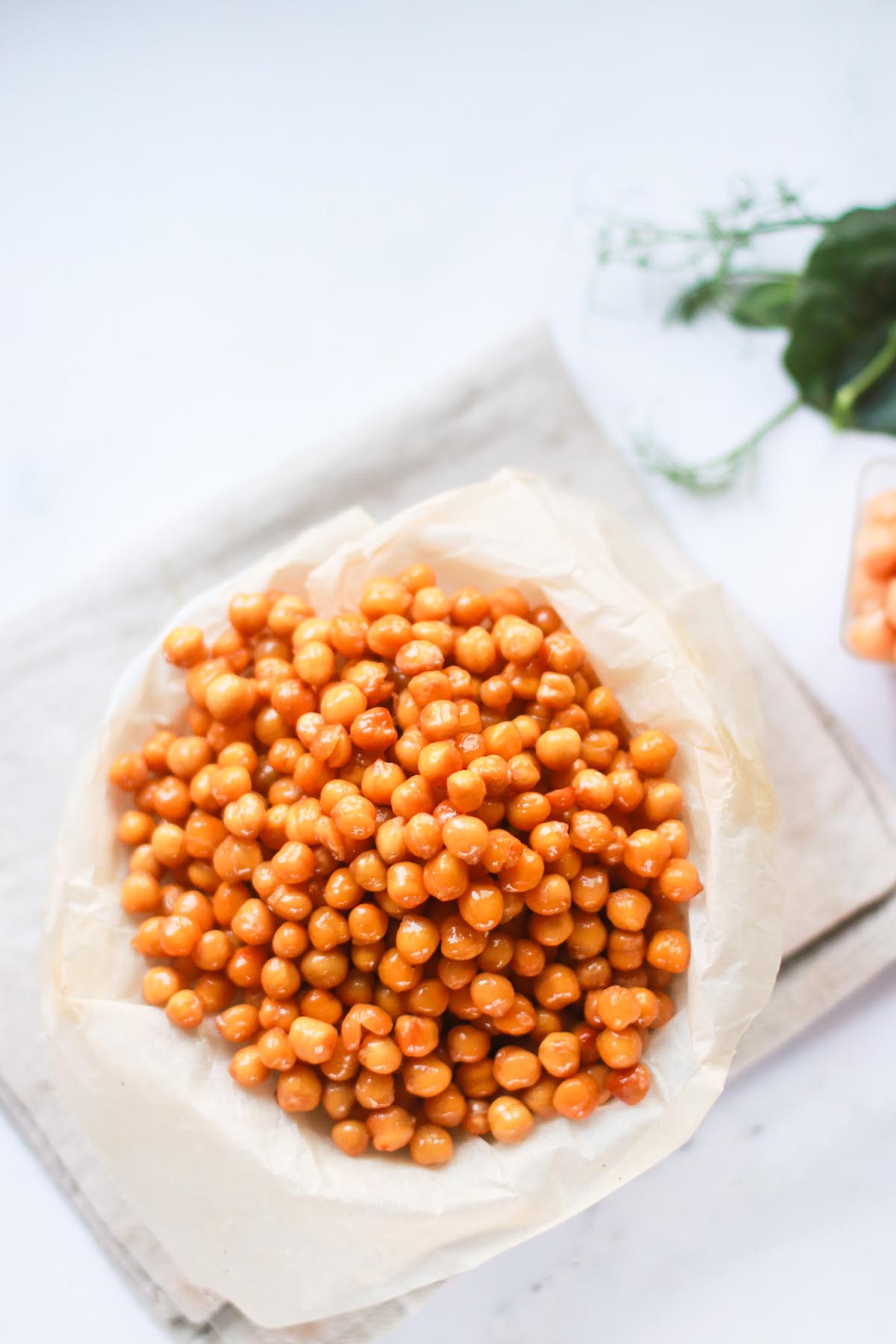 Chickpeas in a bowl on a white table.