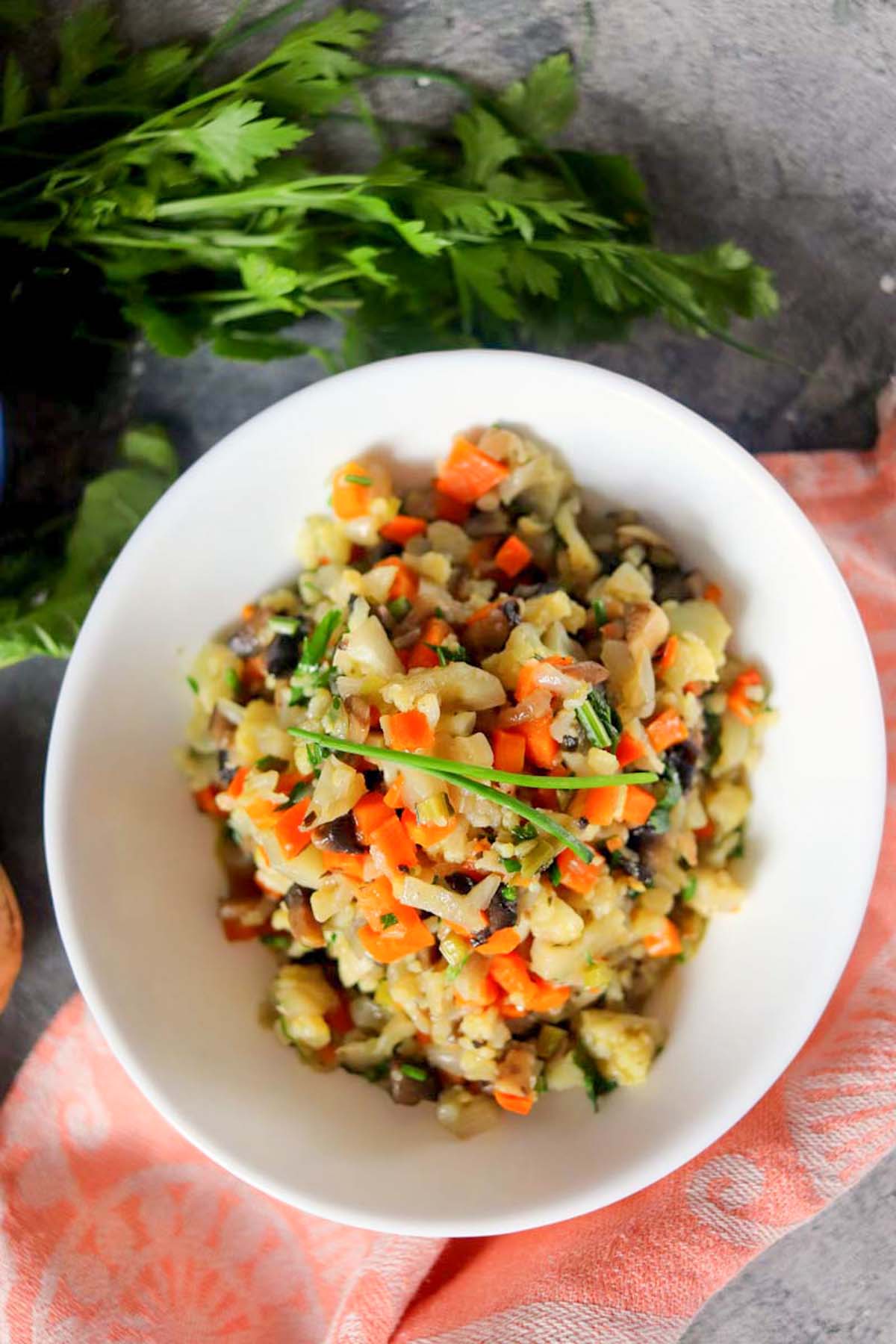Stuffing in a bowl next to sprigs of parsley.