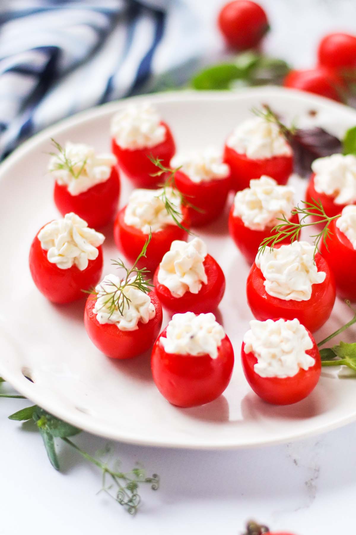 Stuffed cherry tomatoes on a plate.