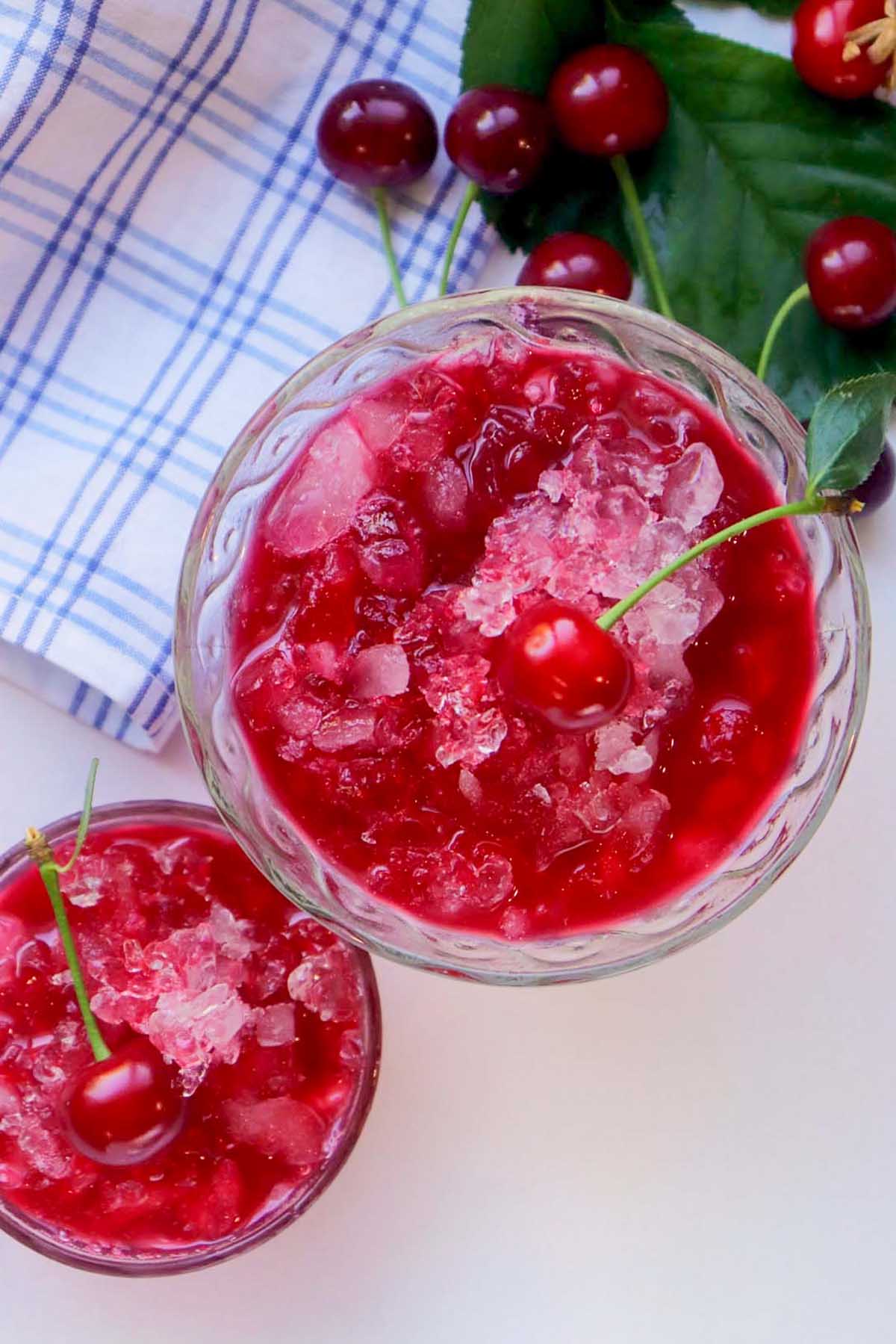 top view of two glasses with cherry snow cones.
