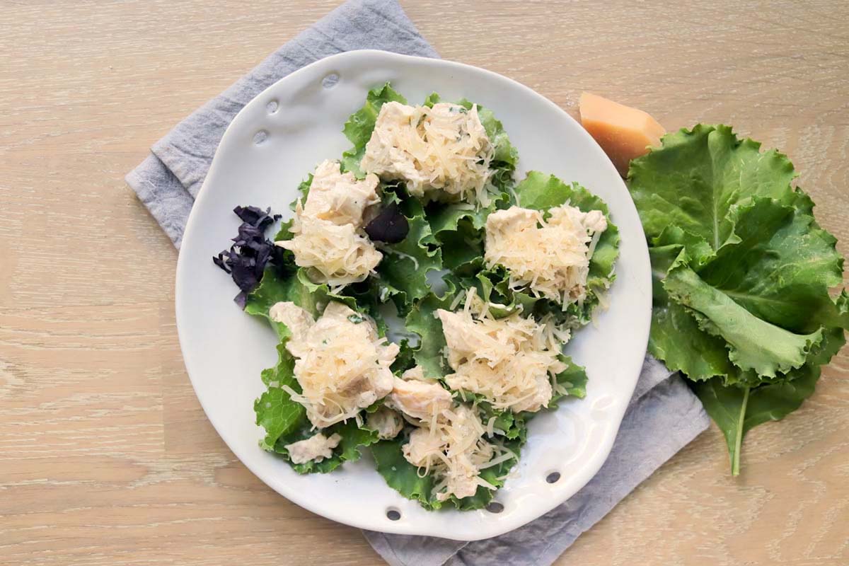 Lettuce wraps on a plate set on a kitchen towel.