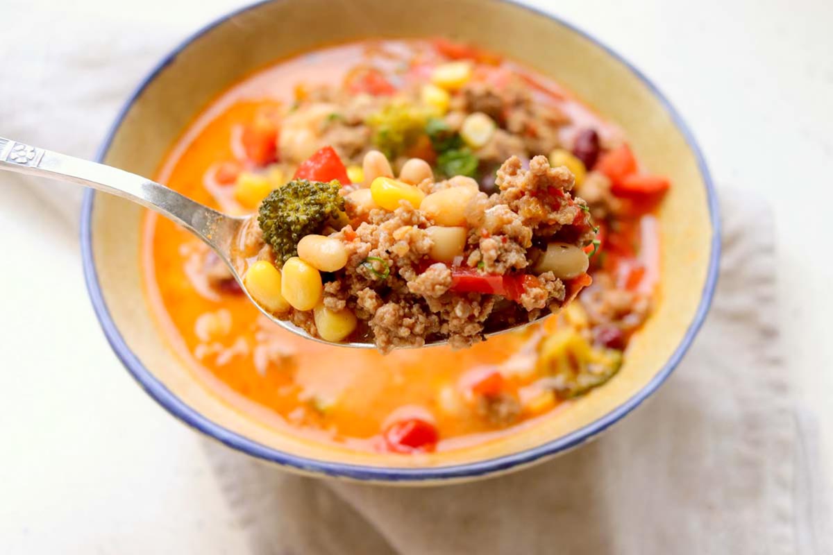 Taco soup scooped on a spoon.