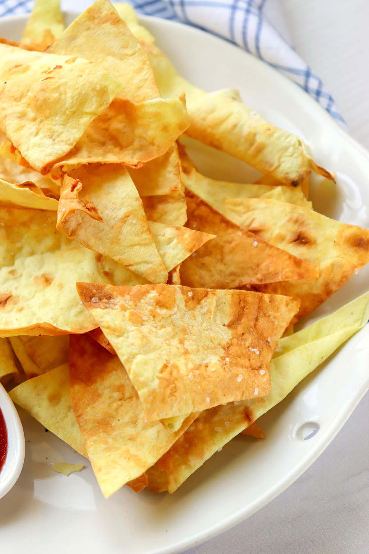 close up view of tortilla chips on a plate.