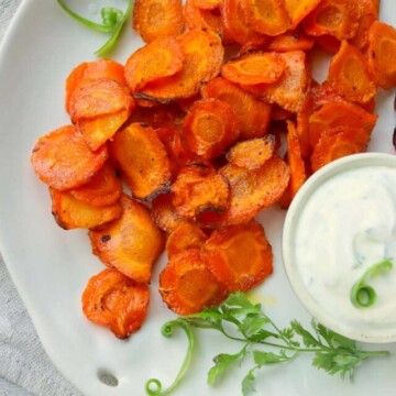 air fried carrot chips on a plate with ranch dip.