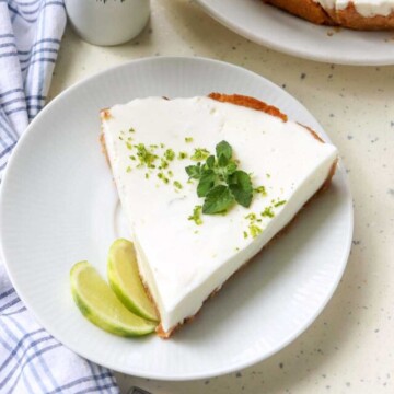 slice of pie on a plate next to a whole pie.