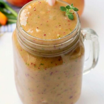 smoothie in a jar with a pink straw.