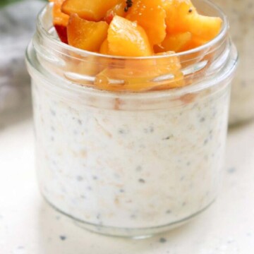side view jar of peach overnight oats.