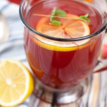 honey tea in a glass with lemon and mint.