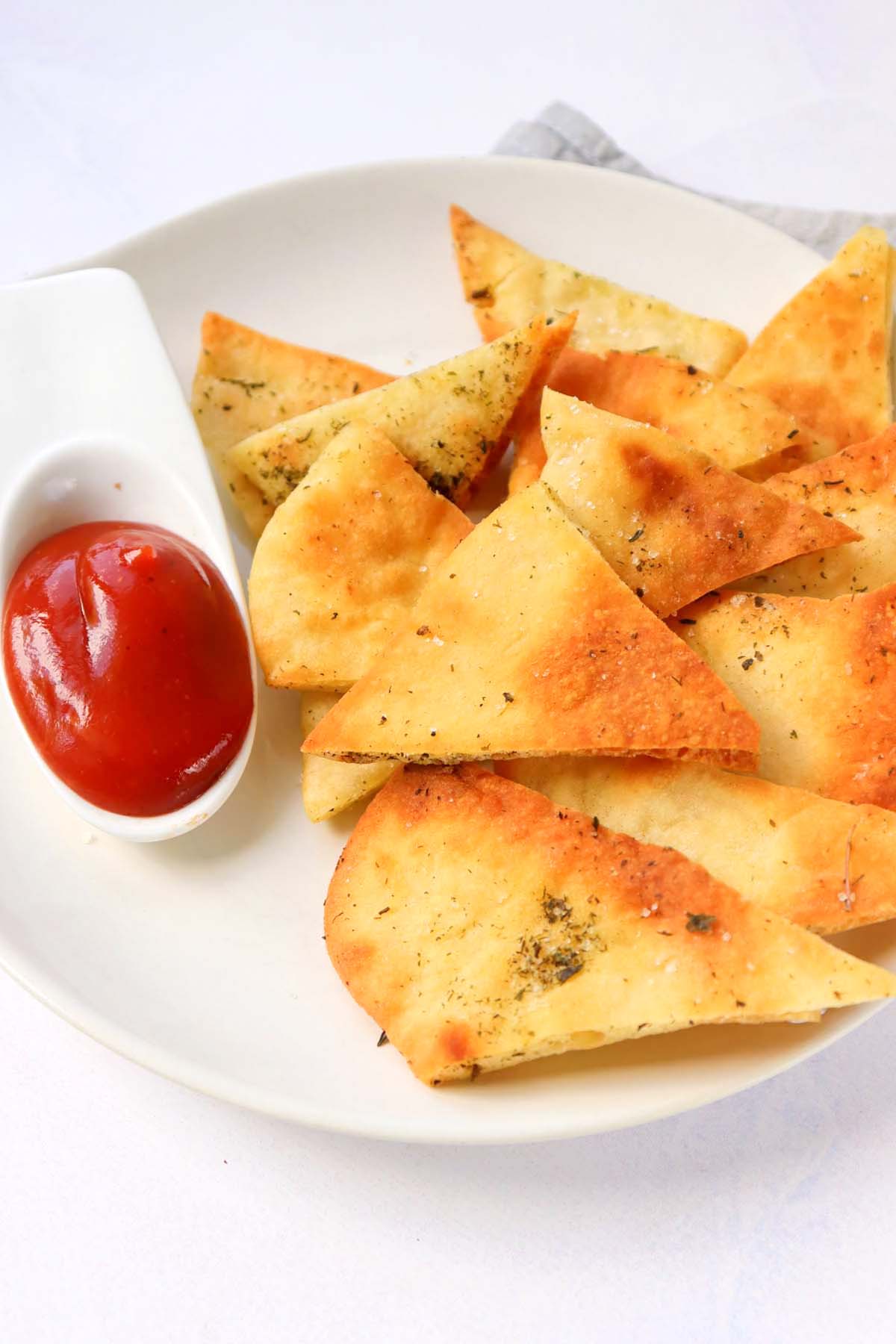 Pita chips on a white plate.