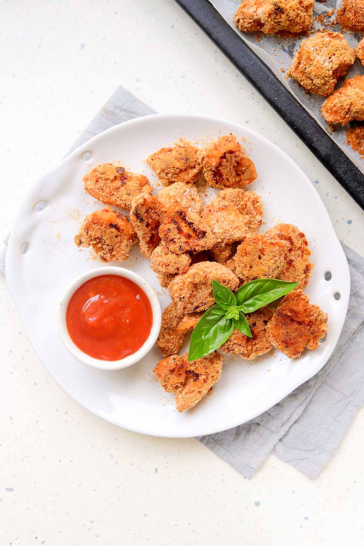 Chicken on a plate with dipping sauce.