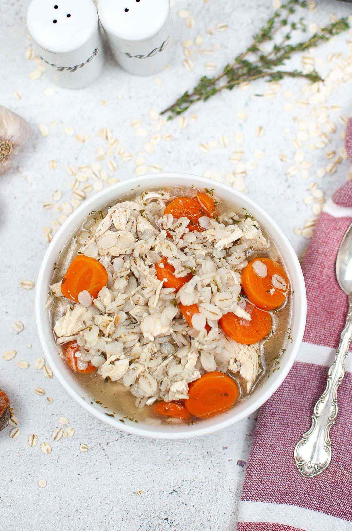 Soup in a bowl with sliced carrots.