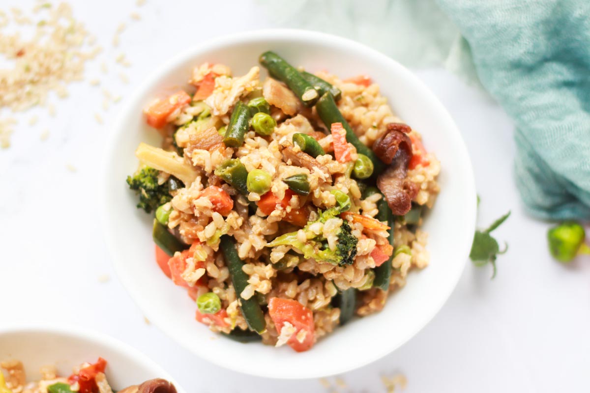 Fried rice in a bowl on a white table.