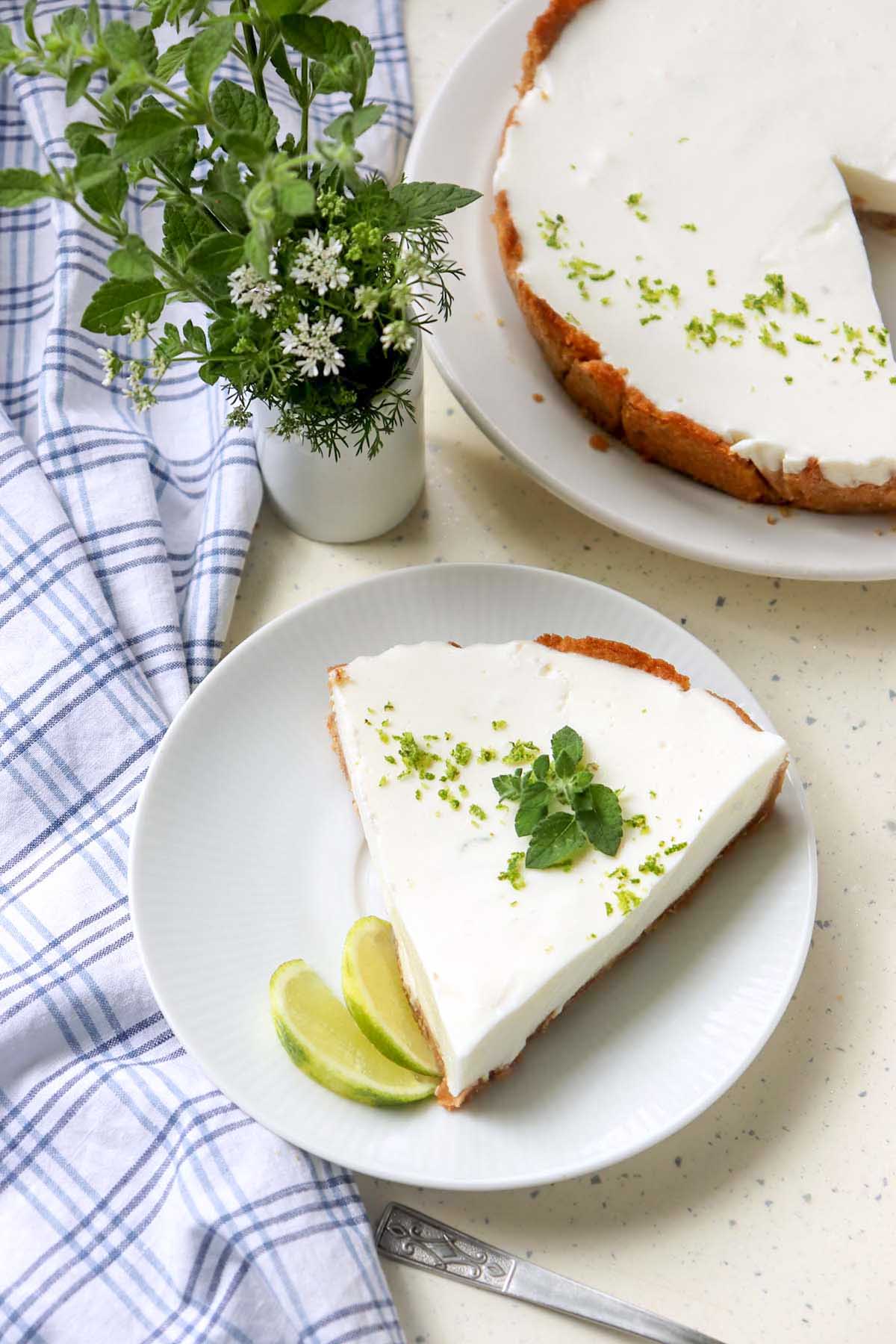 Slice of pie on a plate next to a whole pie.