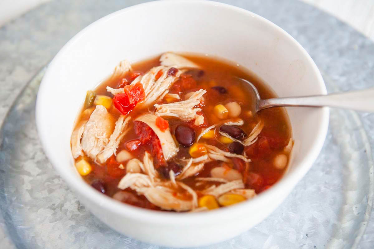 Bowl of taco soup with a spoon in the bowl.