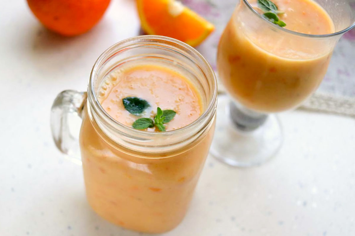 Two glasses of frozen orange drink.