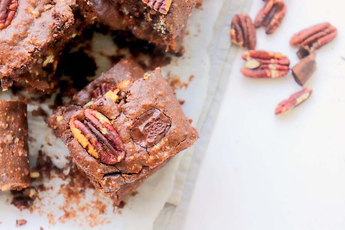 Stacks of brownies on a kitchen towel.