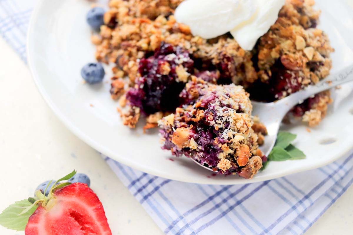 Berry crumble on a spoon.