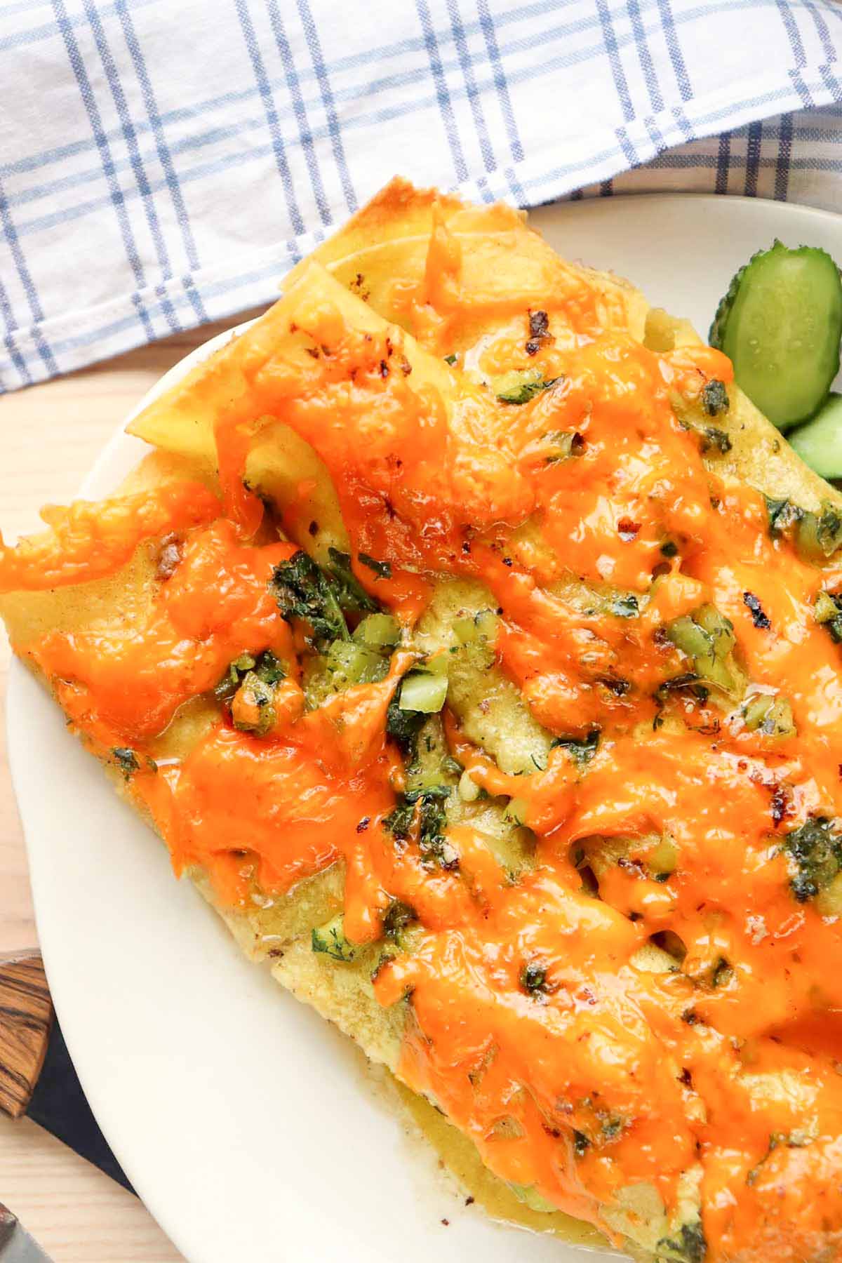 cheesy enchiladas on a plate.
