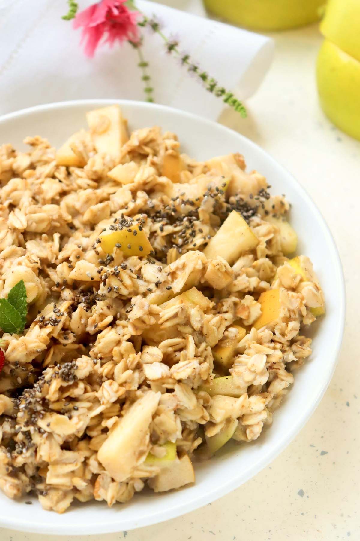 Chunky oatmeal in a white bowl.