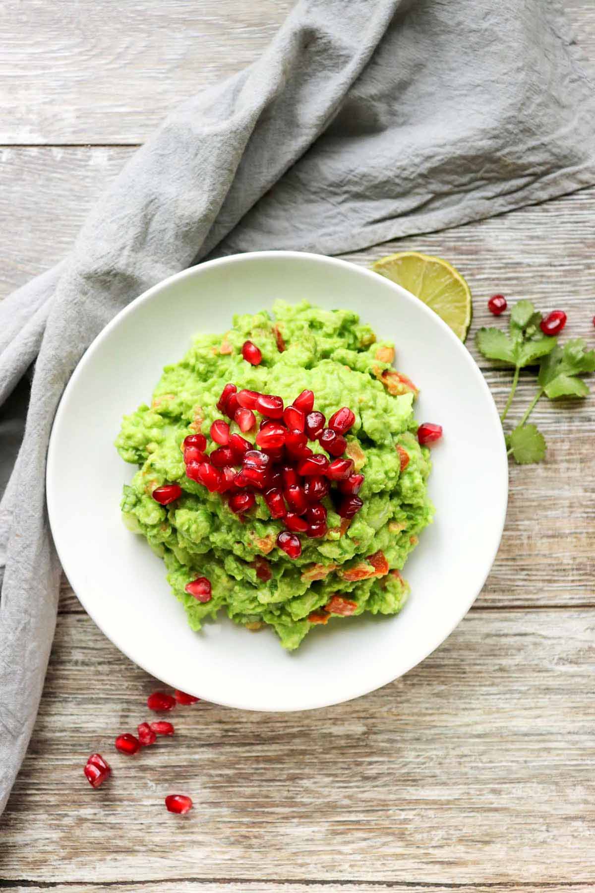 pea guacamole topped with pomegranate seeds.