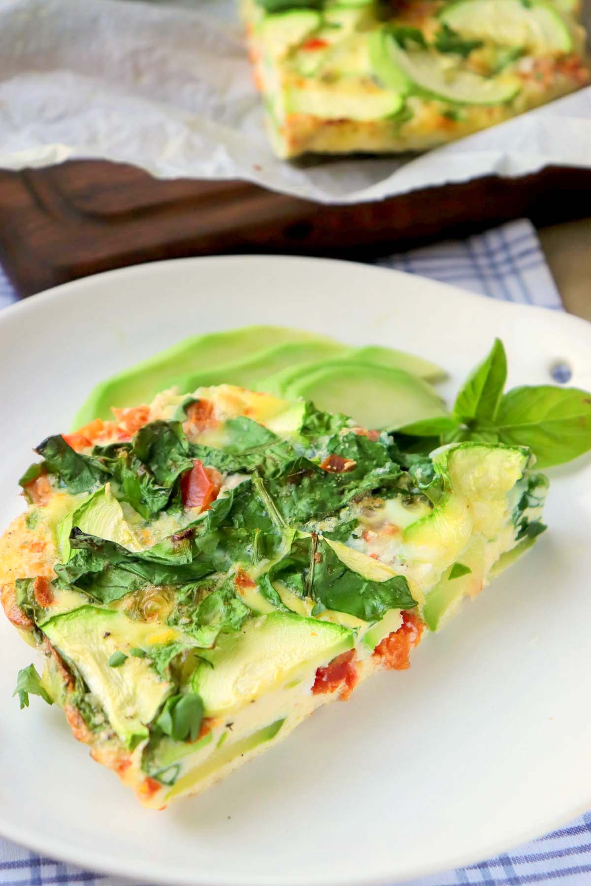 A slice of egg bake on a white plate.