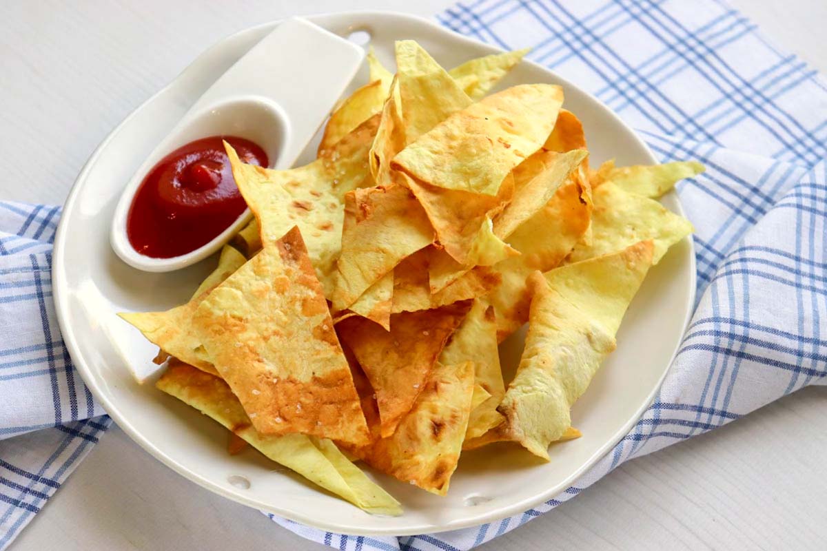 Tortilla chips on a plate with salsa.