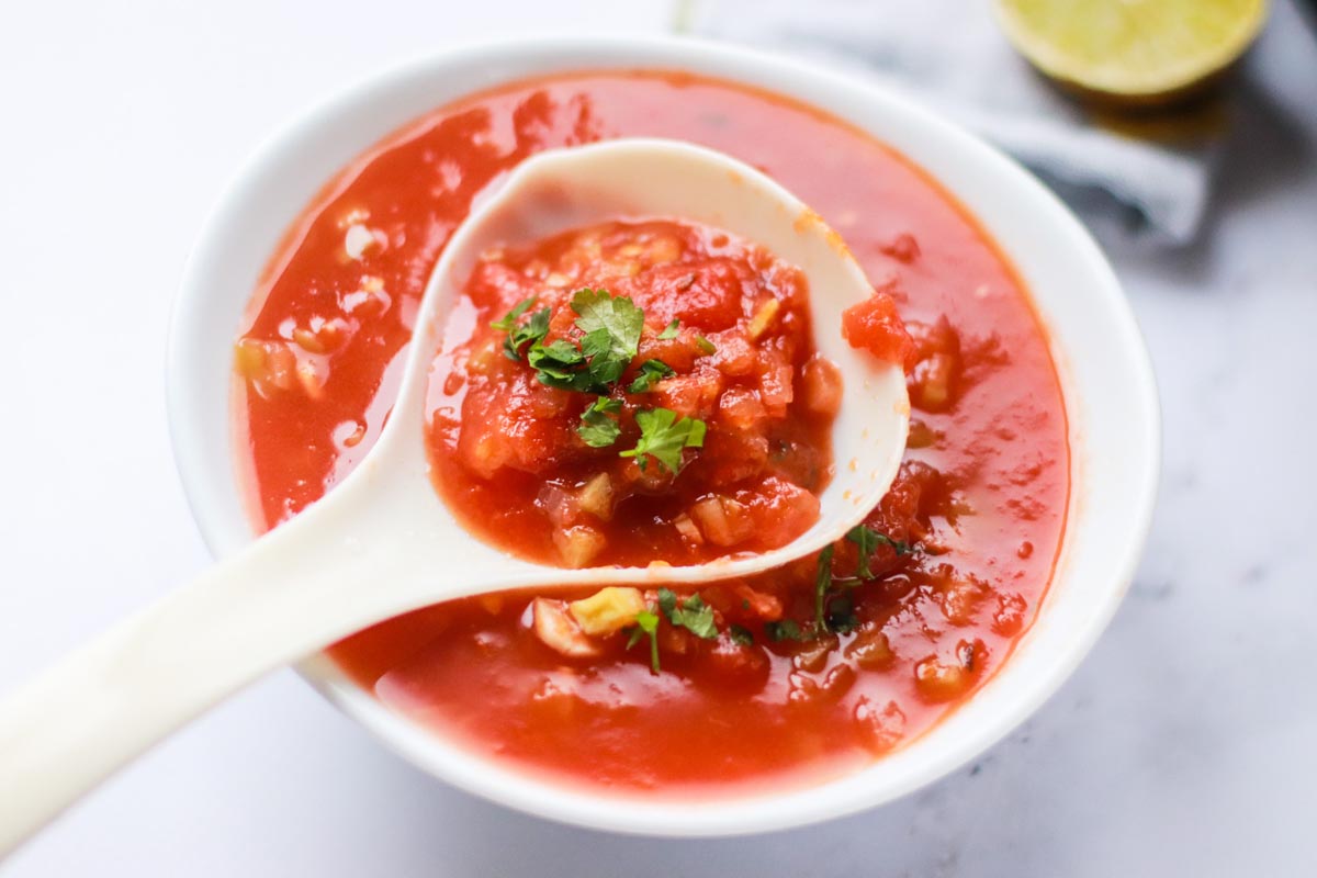 Salsa scooped on a serving spoon.