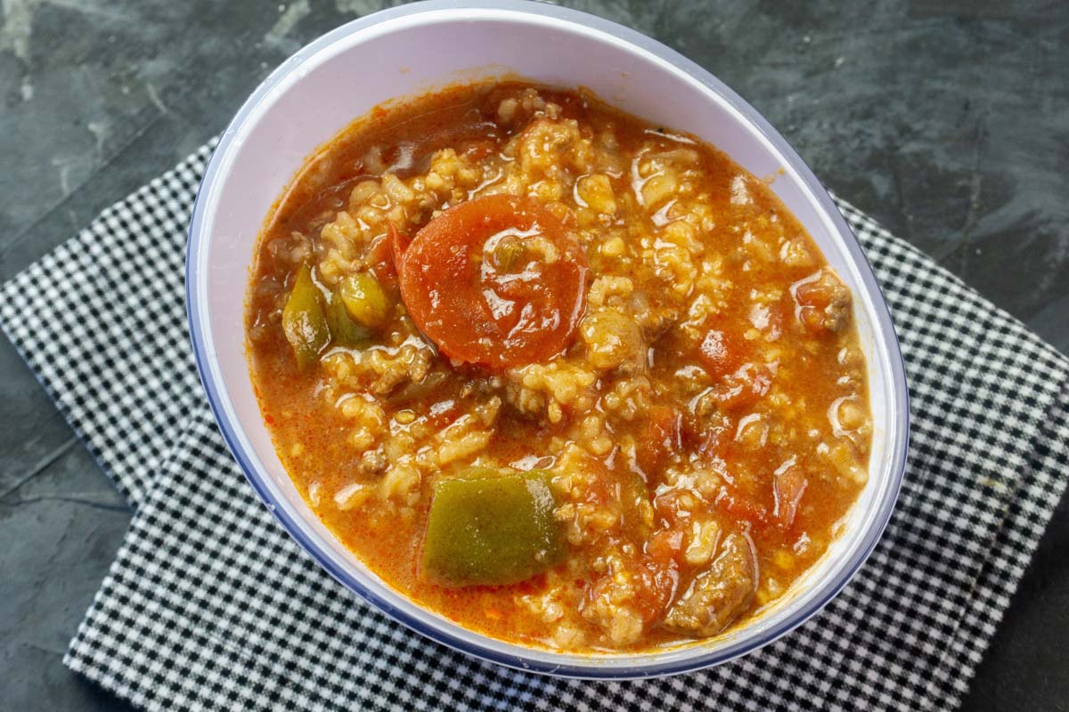 Soup in a bowl that is set on a kitchen towel.