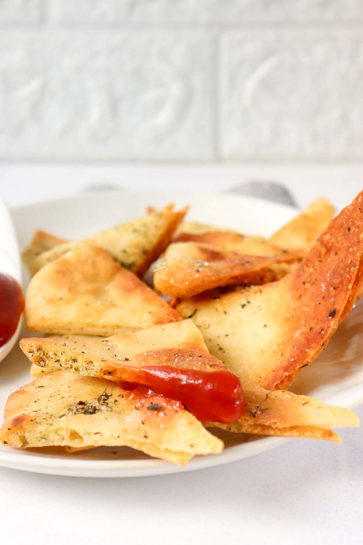 side view of pita chips on a plate.