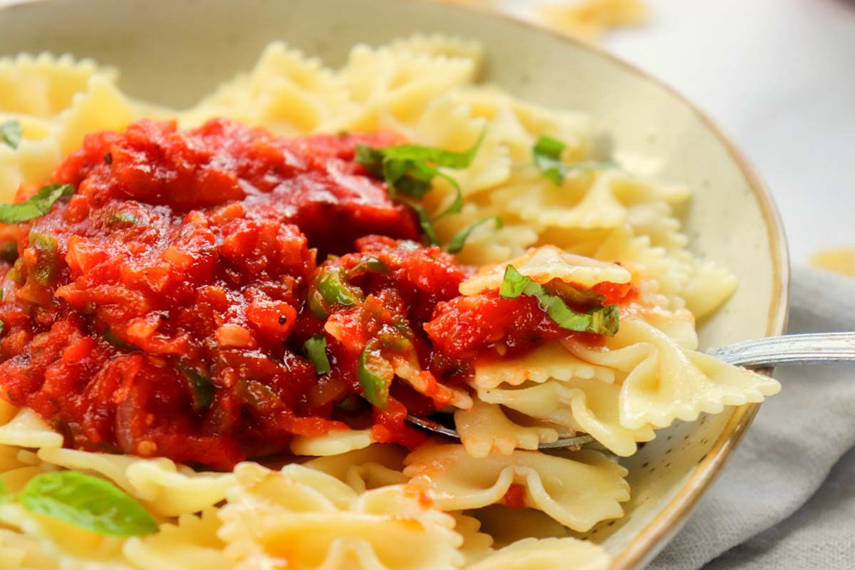 Sauce on bowtie pasta.