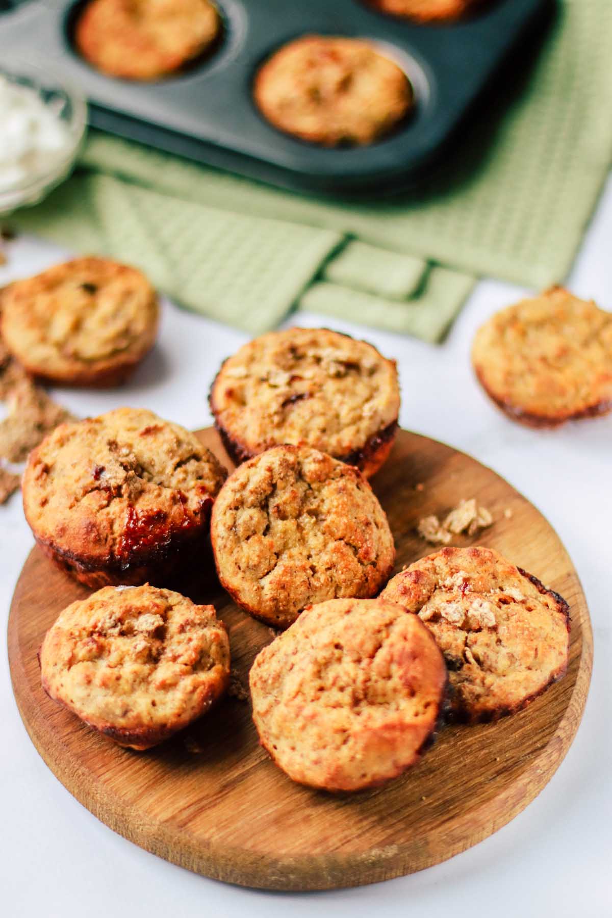 bran muffins stacked on a cutting board.
