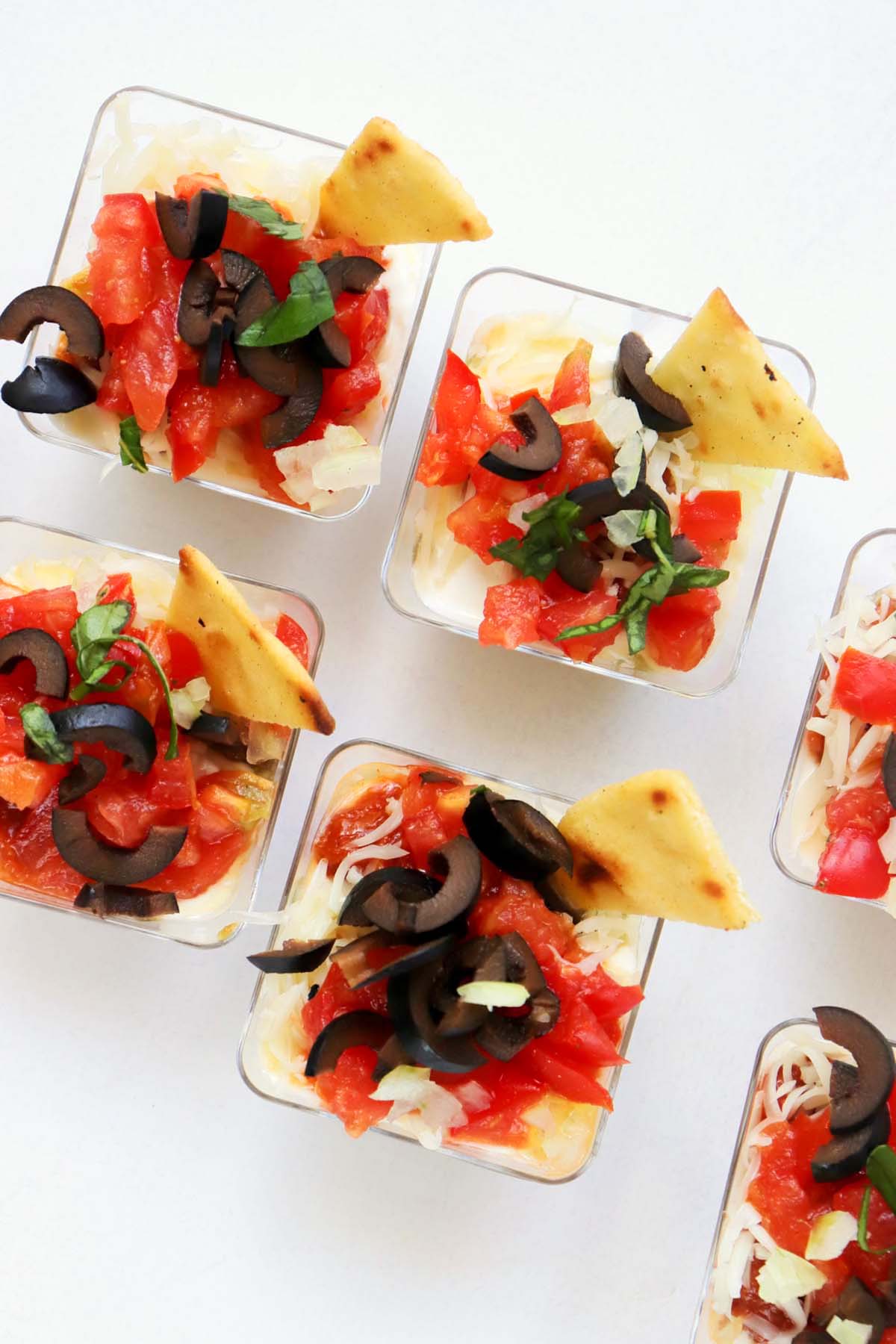 Taco cups with a chip in each cup.