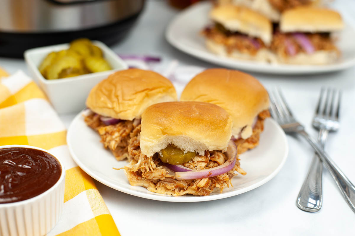 side view of bbq chicken sliders on a plate.