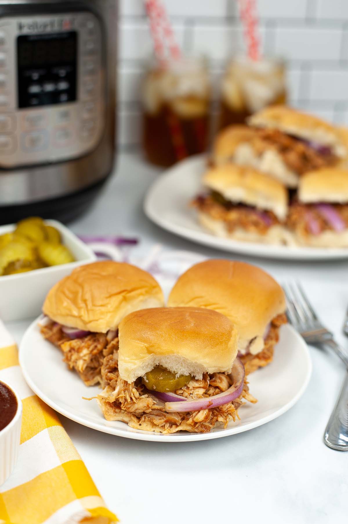 Sliders on a plate in front of the Instant Pot.