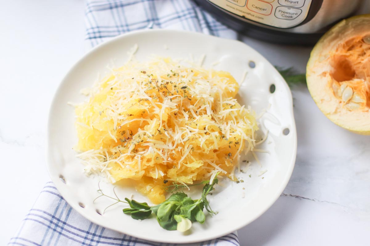 Squash on a plate in front of the Instant Pot.