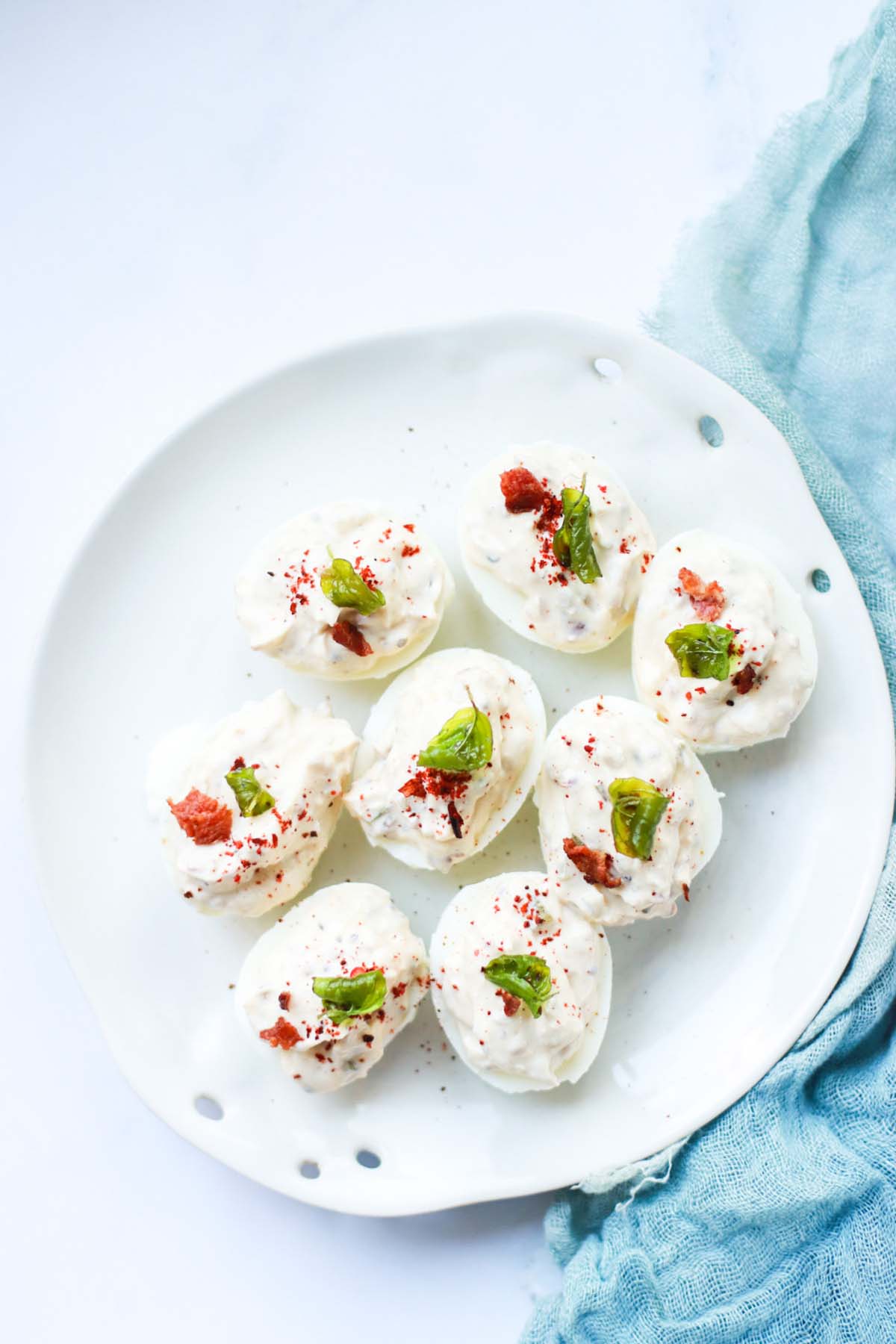 top view of deviled eggs on a white plate.
