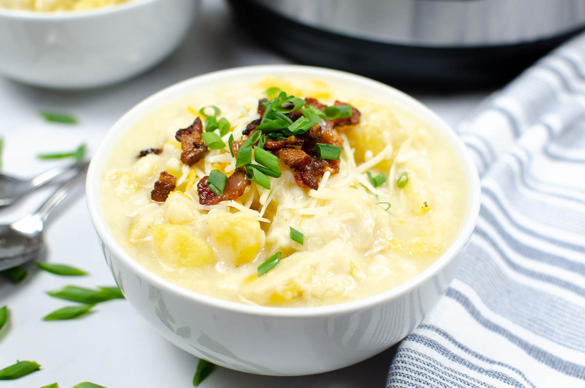 Potato soup in a white bowl.