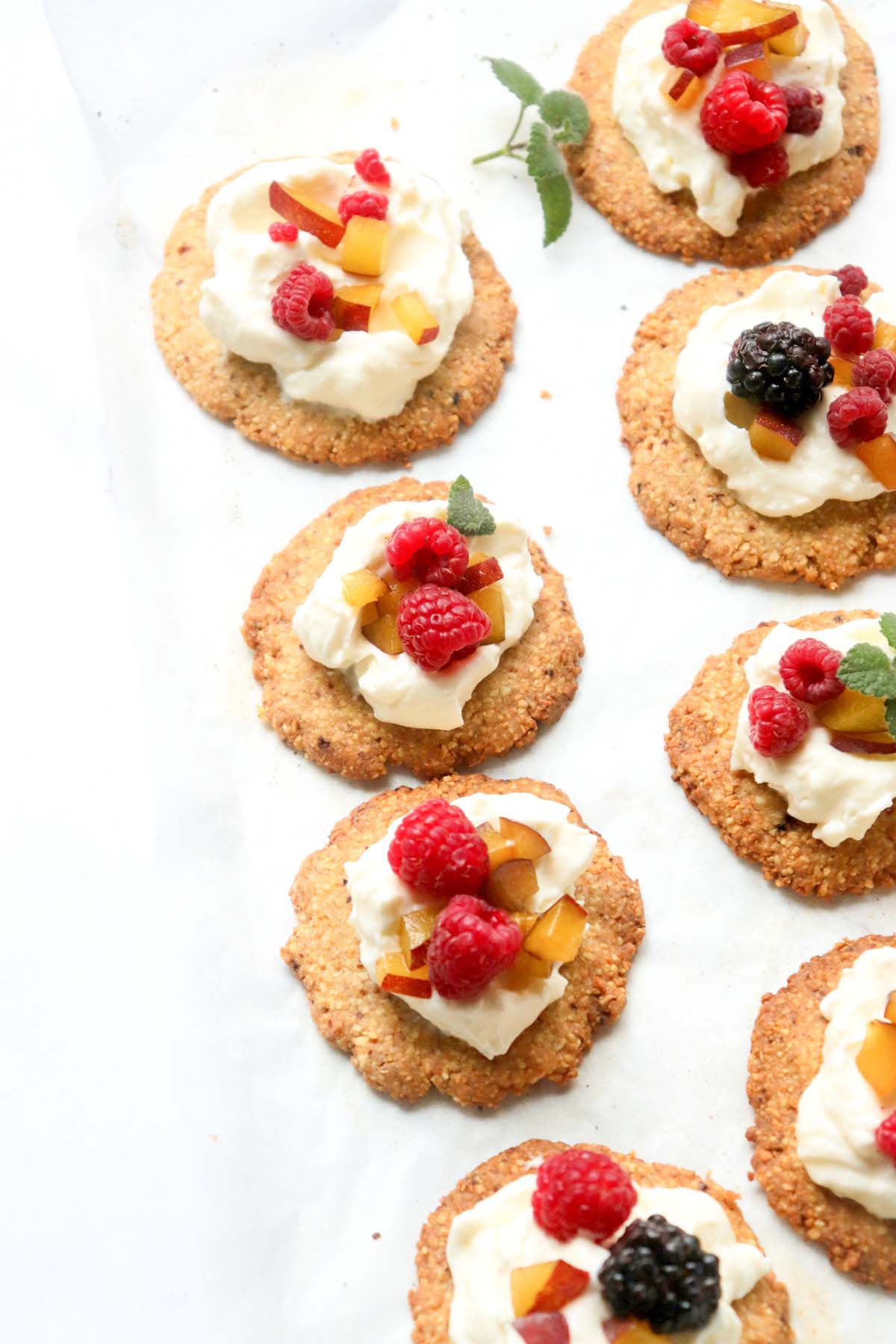 sugar cookies lined up on parchment paper.
