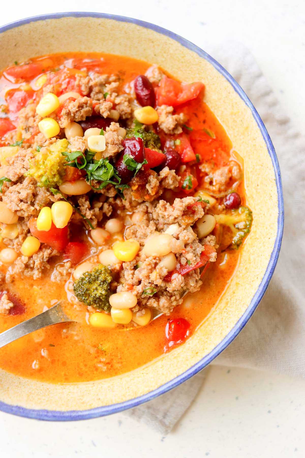 Taco soup in a bowl with a spoon.