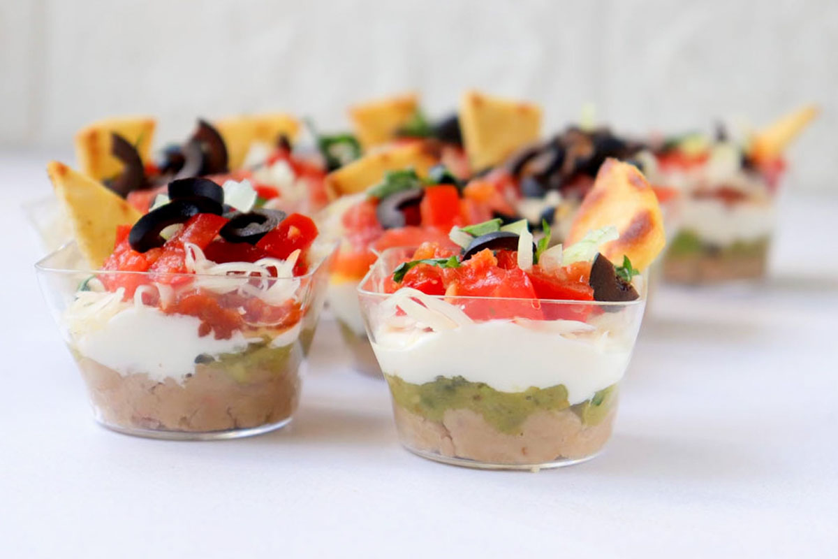 Assembled taco cups on a white table.