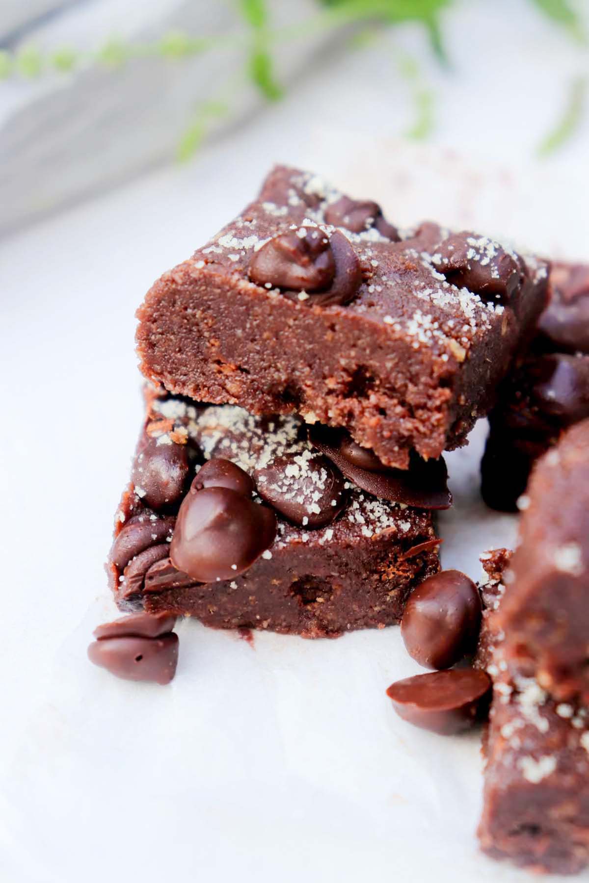 Stacked cookie bars on a white table.