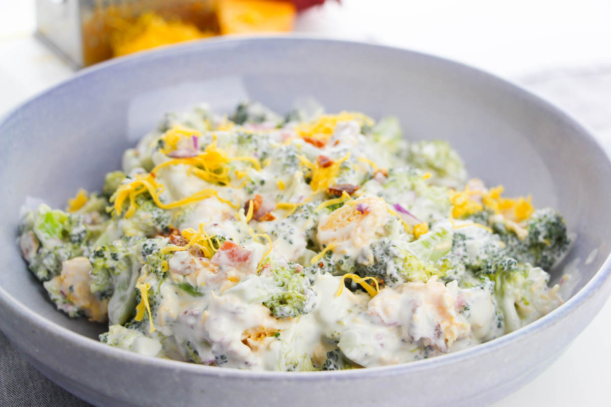 Broccoli salad in a blue bowl.